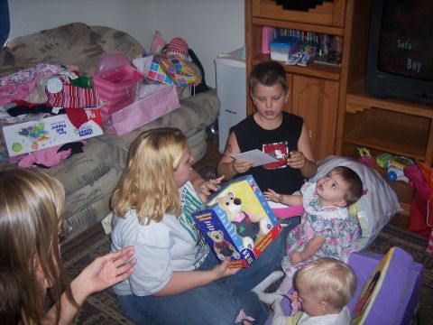 1972 Ford Ranchero - A group of people are sitting on the floor and opening presents in a living room.