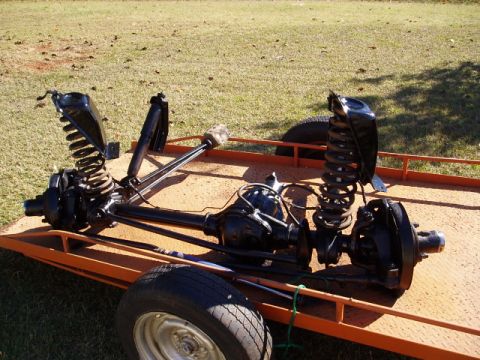 1980 Ford Bronco - Front and rear axles with suspension components are shown on a trailer.