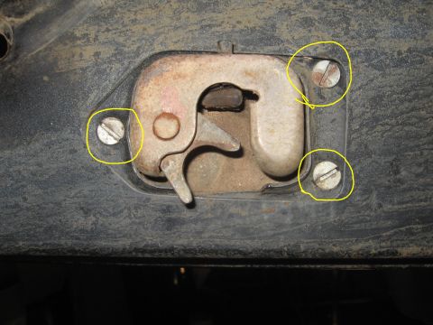 1979 Ford Bronco - Detail of a tailgate latch mechanism, showing wear and mounting screws.