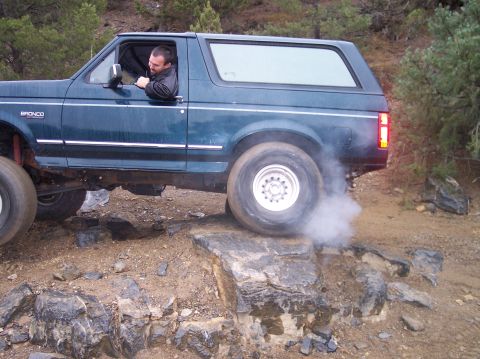 1995 Ford Bronco - This 1995 Ford Bronco navigates a rocky trail, kicking up smoke as it climbs.