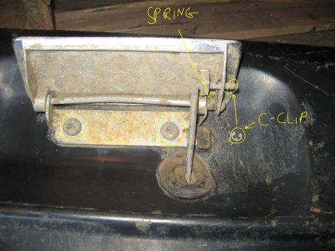1979 Ford Bronco - This photo shows the internal components of a tailgate latch, including a spring and c-clip, with labels.