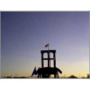 1972 Ford Ranchero - A lifeguard tower stands tall against a clear sky, with flags flying. The Supermotors logo is visible at the bottom.