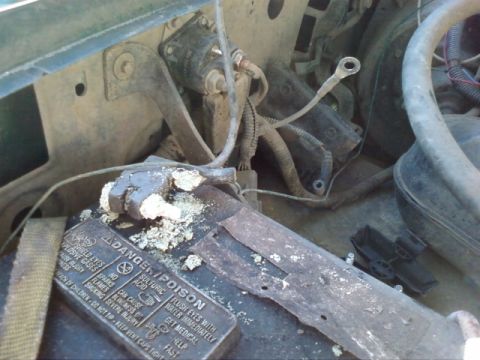 1995 Ford Bronco - Close-up of a vehicle's battery and starter solenoid, showing corrosion.