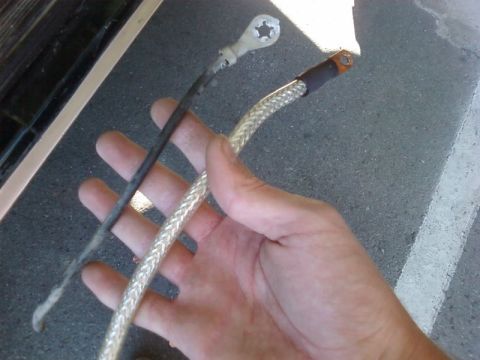 1995 Ford Bronco - Comparing an old, corroded battery cable with a new braided one.