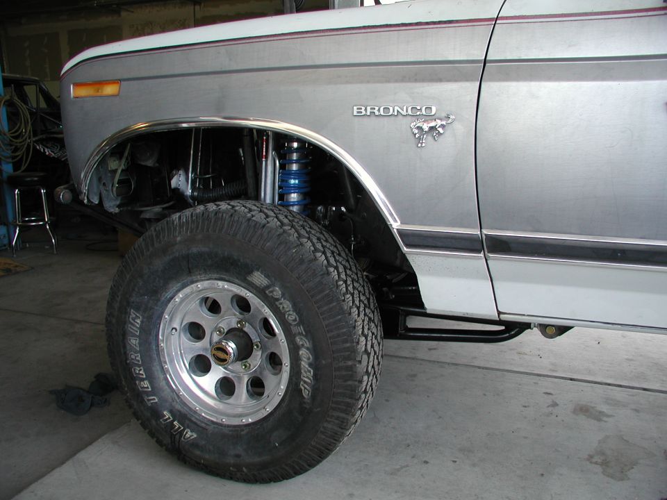 Silver Bronco with lifted suspension and off-road tire