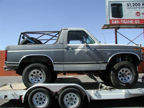 1980 Ford Bronco - This lifted 1980 Ford Bronco features a custom roll cage and is shown on a trailer.