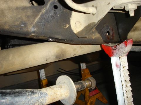 1996 Ford Bronco - Close-up view of a vehicle's undercarriage, supported by jack stands for maintenance.