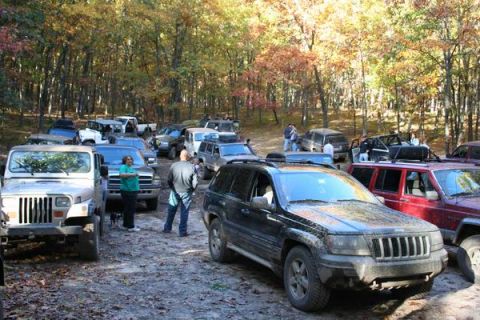 1992 Jeep Cherokee - Multiple Jeeps are gathered in a wooded area during the fall.