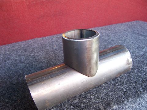 1991 Ford Bronco - A metal pipe fitting is shown, with one section perpendicular to the other.