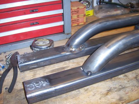 1991 Ford Bronco - Custom metal sliders fabricated on a workbench, with tools nearby.