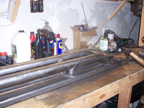 1991 Ford Bronco - Metal tubing and fabrication supplies on a workbench.