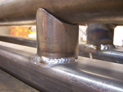 1991 Ford Bronco - The photo shows a close-up view of metal tubing that has been welded together, possibly for a vehicle modification.