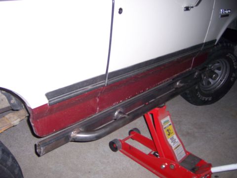 1991 Ford Bronco - Custom fabricated sliders are installed on a 1991 Ford Bronco, which is supported by a red hydraulic jack.