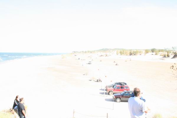 Red 1992 Jeep Cherokee parked on sand near beach