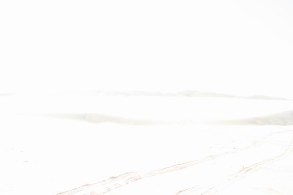 Dunes with tire tracks and SUPERMOTORS watermark