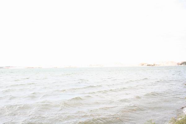 Water with distant shoreline and Supermotors logo