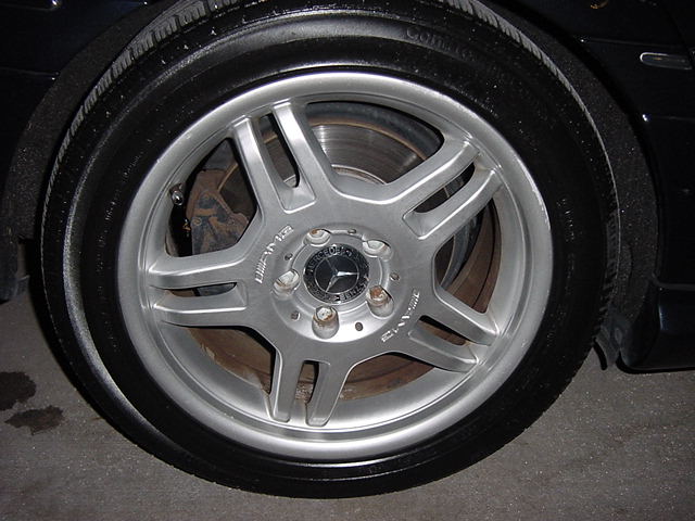 Close-up of a Mercedes-Benz AMG wheel with 'AMG' text visible, showing the tire and brake rotor