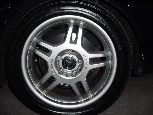 Close-up of a silver Mercedes-Benz AMG wheel with the Mercedes-Benz logo in the center
