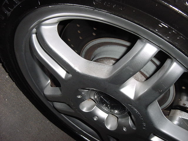 Close-up of a silver Mercedes-Benz AMG wheel with a brake rotor visible behind the spokes