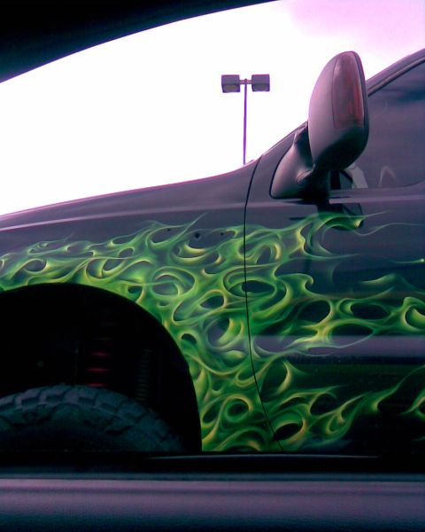 1994 Ford Bronco - This truck features a custom green flame paint job on its side panel and fender.