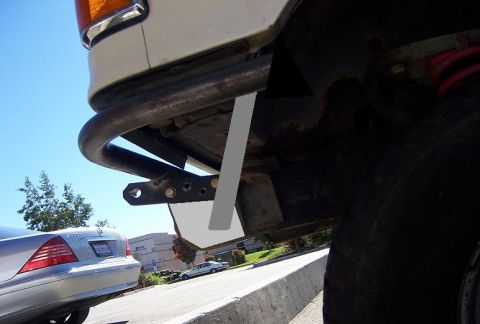 1991 Ford Bronco - Custom fabrication of a front bumper on a white SUV, with a silver sedan visible in the background.