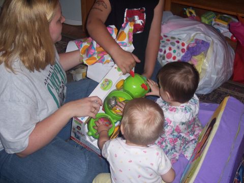 1972 Ford Ranchero - A group of people, including children, are gathered around opening a new toy.