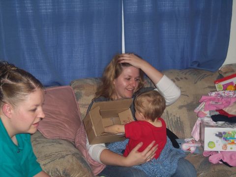 1972 Ford Ranchero - A family gathers on a couch, surrounded by gifts and the joy of a child's curiosity.
