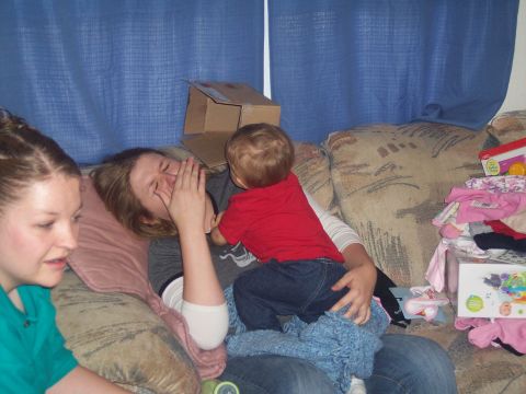 1972 Ford Ranchero - A woman plays with a child on a couch, while another woman looks on from the side.