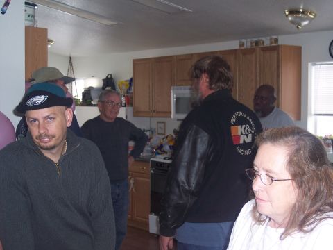 1972 Ford Ranchero - People are gathered in a kitchen, with one person wearing a jacket that says K&N Racing.