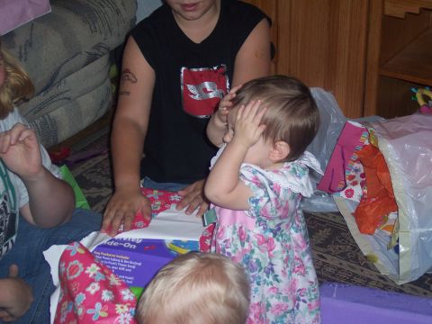 1972 Ford Ranchero - A child covers their eyes while others open gifts, with wrapping paper and bags scattered around.