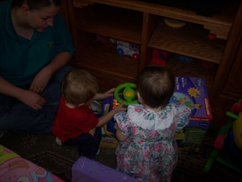 1972 Ford Ranchero - Children interact with a toy steering wheel and a toy box, with a woman observing.