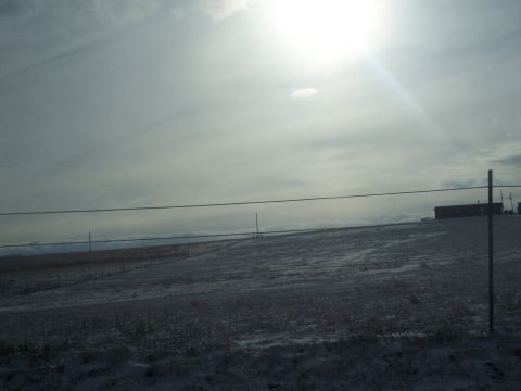 1972 Ford Ranchero - Winter scene with a building on the horizon under a bright, hazy sky.