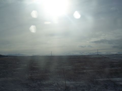1972 Ford Ranchero - A vast, open landscape stretches out under a cloudy sky, with tall radio towers dotting the horizon.