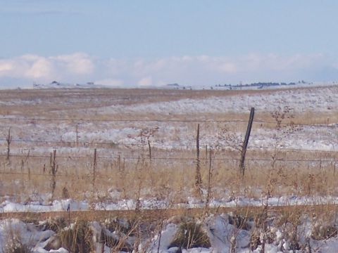 1972 Ford Ranchero - A winter scene shows a field dusted with snow, with dry grass and a fence line visible.