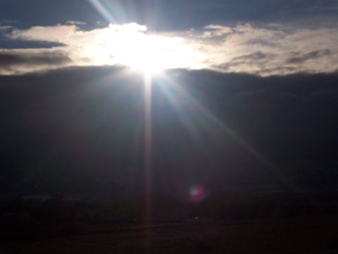 1972 Ford Ranchero - Sunlight breaks through a thick layer of clouds, casting rays across the sky.