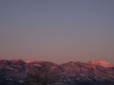 1972 Ford Ranchero - The sky fades from blue to pink over snow-covered mountains at dusk.