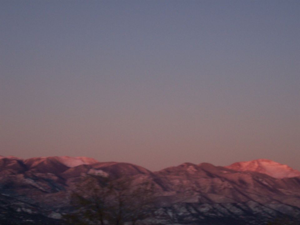 mountains with snow caps lit by sunset