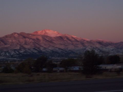 1972 Ford Ranchero - A scenic view of mountains bathed in the warm hues of a sunset, with a hint of snow on their peaks.