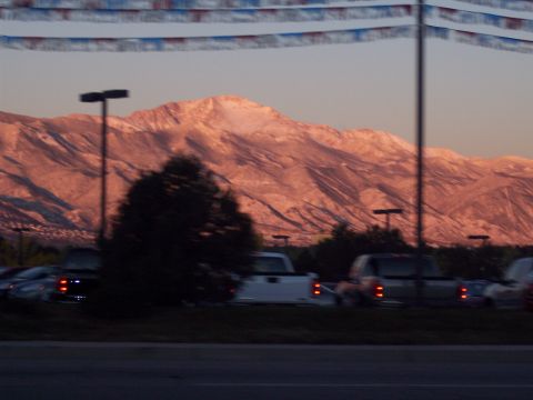 1972 Ford Ranchero - Several trucks are parked in front of a mountain range during sunset.