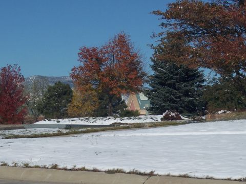 1972 Ford Ranchero - A landscape scene shows snow on the ground, colorful autumn foliage, and a building in the distance.