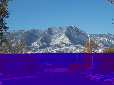 1972 Ford Ranchero - A winter scene shows snow-capped mountains under a bright blue sky, with a street lamp visible.