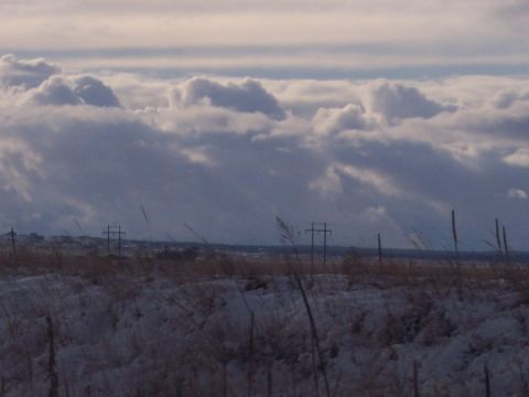 1972 Ford Ranchero - A desolate winter landscape with power lines stretching across a snowy field under a dramatic sky.