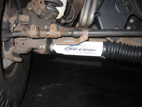 2001 Ford F-150 - The Pro Comp shock absorber and steering linkage are visible on the underside of a vehicle.