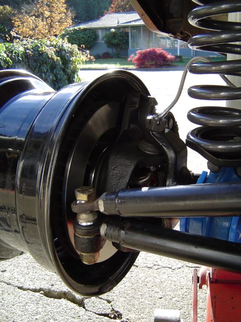 1978 Ford Bronco - A detailed view of a vehicle's front suspension and steering assembly, focusing on the wheel hub and brake components.