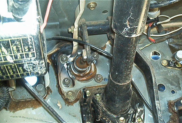 Clutch master cylinder assembly with rusty components and wiring, viewed from above