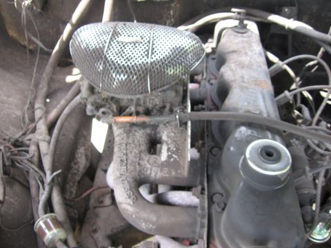 1979 Ford F-150 - Engine bay detail with carburetor and air cleaner assembly. Wiring and hoses are visible.