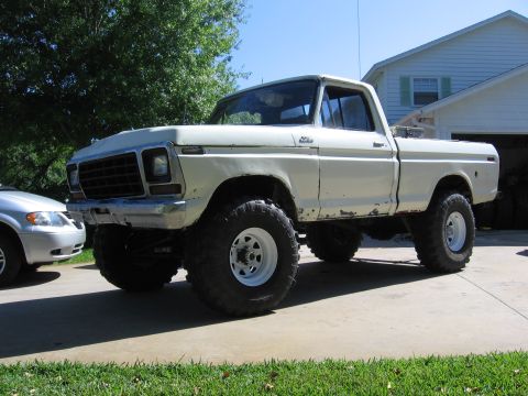 1979 Ford F-150 - This lifted 1979 Ford F-150 pickup truck is shown in a 3q-front view, parked in a driveway.