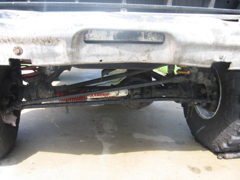 1979 Ford F-150 - The front suspension and steering components of a truck are visible, with a Rancho steering stabilizer installed.