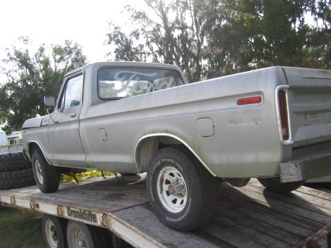 1979 Ford F-150 - Silver 1979 Ford F-150 pickup truck being transported on a flatbed trailer.