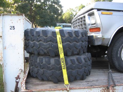 1979 Ford F-150 - Front view of a 1979 Ford F-150 truck, partially obscured by large off-road tires.